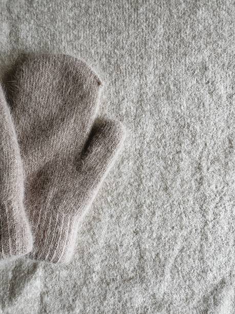 istock Vertical Minimalist Background with Fuzzy Mitten Detail on Textured Fabric. 2237311224
