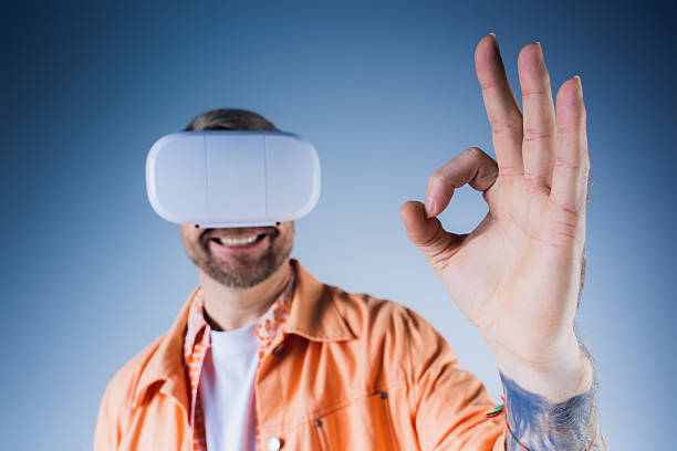 A young man enjoys an immersive experience in the metaverse while wearing a VR headset.
