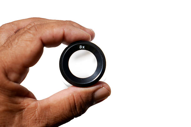 istock hand picked photographic loupe on a white surface Magnification 8X  isolated on white background. 2237320906