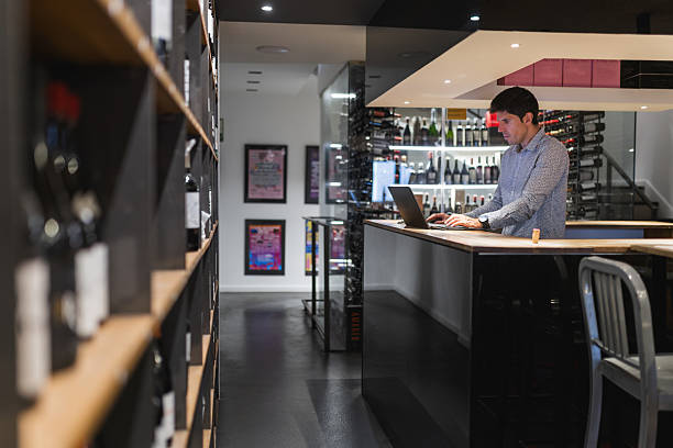 Young man using a laptop in his small business.