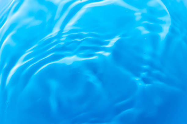 istock Transparent blue clear water surface texture with ripples, splashes and bubbles. Abstract summer banner background Water waves in sunlight with copy space Cosmetic moisturizer micellar toner emulsion 2237323325