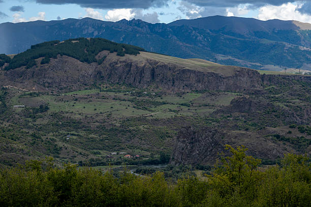 istock Vast Canyon Landscape Surrounded by Rolling Mountains Under Moody Sky 2237325814