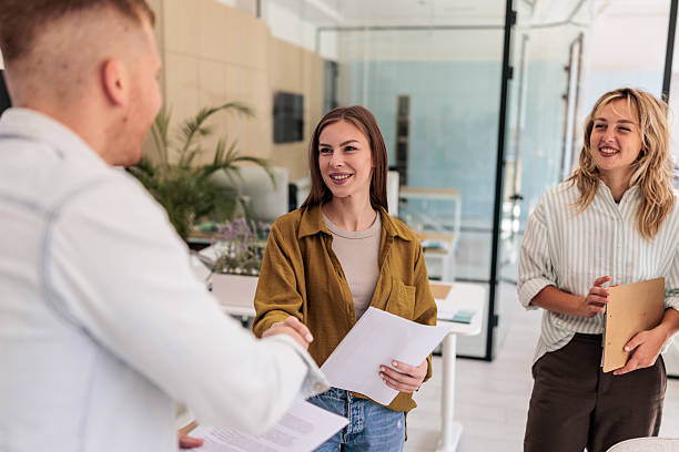 istock Colleagues Shaking Hands in Office After Successful Project 2237327617