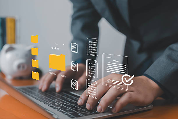 istock Businessman managing digital folders and documents on laptop with virtual interface, symbolizing cloud storage, data management, organization, workflow, and modern technology solutions. 2237330254