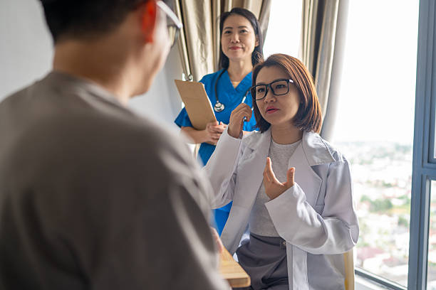 istock Medical Expertise in Action: Doctors Inform Patient 2237330632