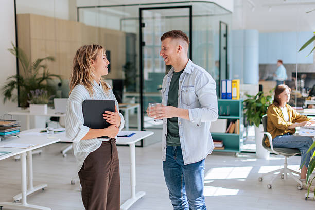 istock Smiling Colleagues Having Casual Talk in Office 2237333231