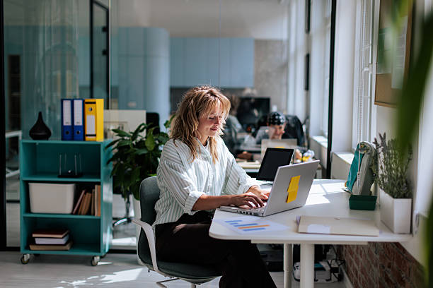 istock Woman Working on Laptop at Desk in Office 2237333706