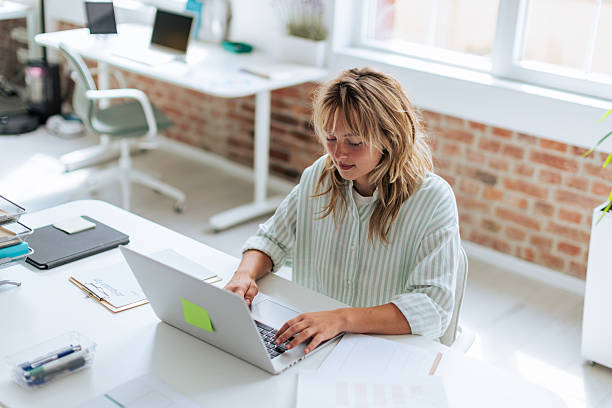 istock Focused Businesswoman Working on Laptop in Office 2237334298
