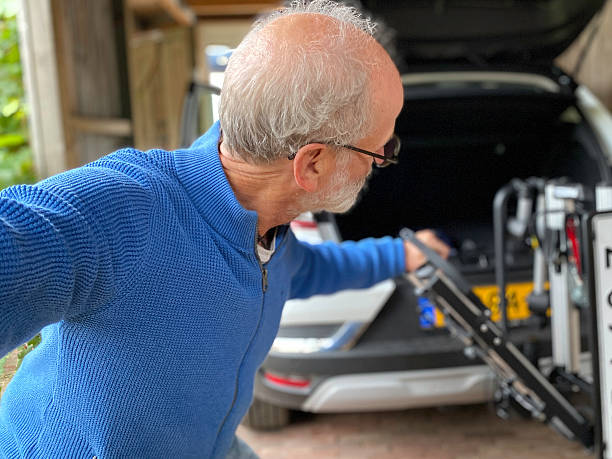 istock Senior man installing  the Towbar for the Bicycle Carrier. 2237339399
