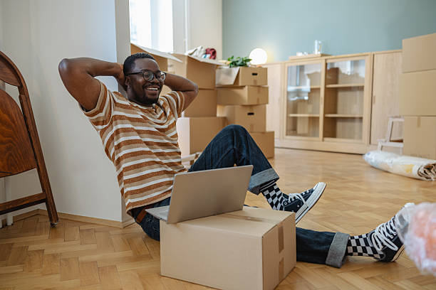istock Relaxed man using laptop in his new apartment 2237341345