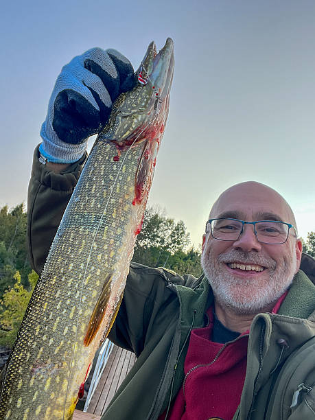 Proud mature man showhing the fish he caught