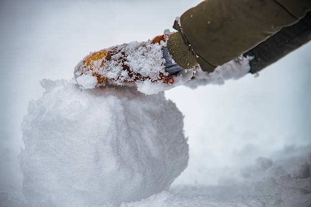 istock Child Hand With Glove Making Snowball In Winter 2237341951