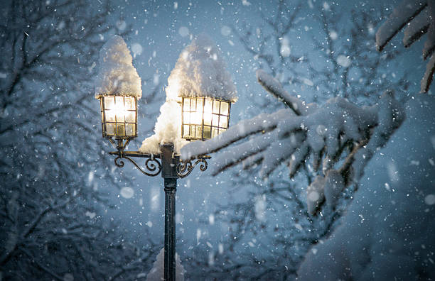 istock Snow Covered Street Lamp Glowing In Winter Night 2237342002