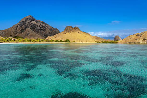 istock Tropical Island Beach With Turquoise Waters And Dramatic Mountains Over Calm Sea 2237348564