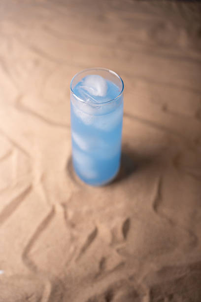 istock chilled blue beverage in glass with ice on sandy surface creating a refreshing summertime vibe under soft lighting creating a serene contrast of colors and textures, aesthetic, clear, refreshment 2237352103