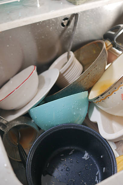 istock Dishes piled in a sink after a busy meal preparation 2237353100