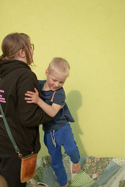 istock An older sister helps her younger brother, reflecting the warmth and support 2237353138
