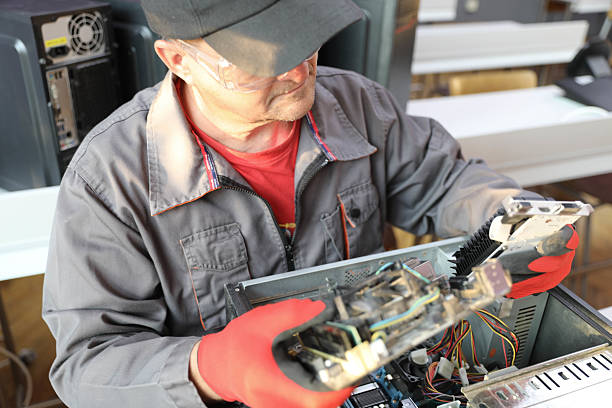 istock IT Technician Holding Circuit Board and Hard Drive During Repair 2237355070
