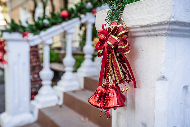 istock A red and gold bell is hanging from a white railing 2237355379