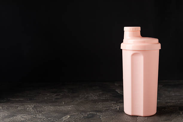 istock Protein shake with protein powder on a colored background. The powder is mixed with water or milk. A dietary supplement for a balanced diet. Whey protein. Fitness and gym diet nutrition. 2237357034