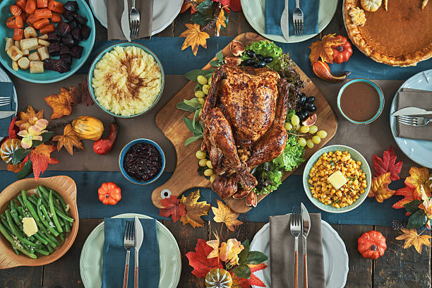 istock Having Stuffed Turkey for Thanksgiving Holiday Dinner with Vegetables, Pumpkin Pie and Side Dishes 2237358345