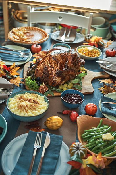 istock Having Stuffed Turkey for Thanksgiving Holiday Dinner with Vegetables, Pumpkin Pie and Side Dishes 2237358389