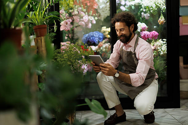 istock Male florist using tablet in flower shop 2237358640
