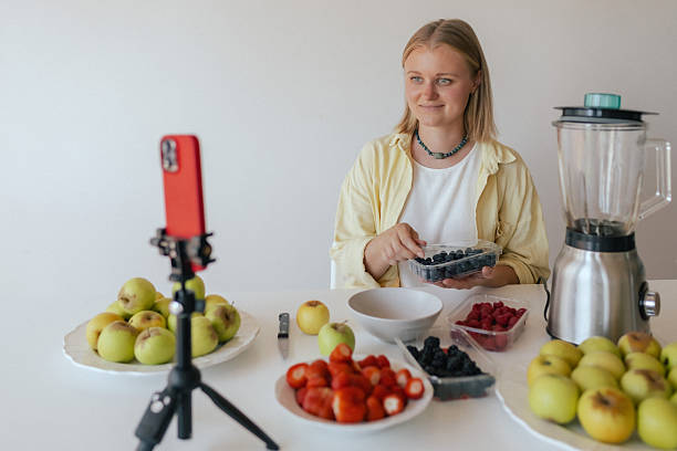 istock Middle-aged woman preparing homemade fruit leather, slicing fresh fruit in her kitchen for a healthy snack. Part of a series on organic treats and natural living. User-generated content 2237362591