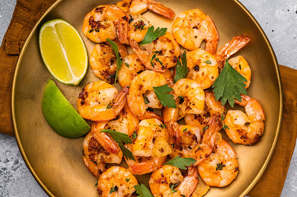 istock BBQ dinner with roast Shrimps Prawns in a plate. Gray background. Top view 2237364478
