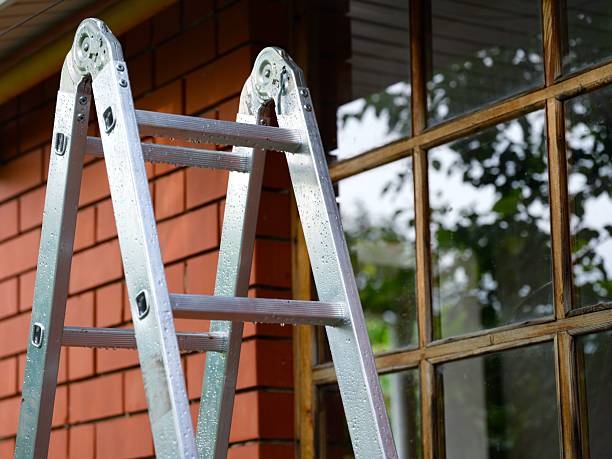 istock A ladder with rain drops standing next to a house 2237364641