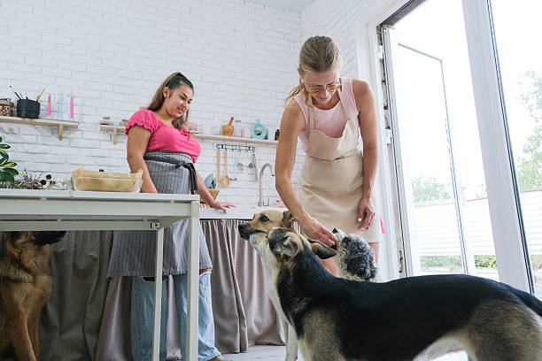 istock two women baking pears with ricotta and walnuts, and playing with dogs 2237365166
