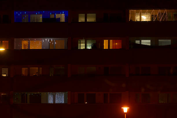istock Illuminated Windows in an Apartment Building at Night Creating Atmosphere 2237366587
