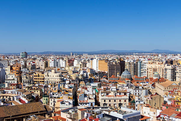 istock Panoramic view of Valencia city rooftops under a clear blue sky, showcasing diverse architecture and vibrant urban life, ideal for travel and cityscape themes. 2237370583