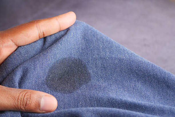 istock Stain on blue fabric being inspected closely during the day 2237381867