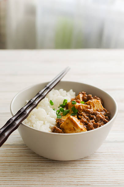 istock Mapo tofu dish in spicy sauce with minced beef in a ceramic bowl on a white background. Dish from Sichuan province. Traditional Asian food concept. Selective focus. Vertical orientation. 2237385760