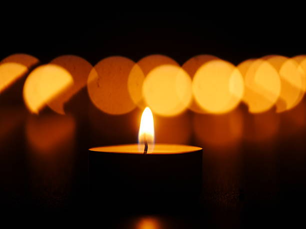 istock Candle is lit in a dark room 2237388847