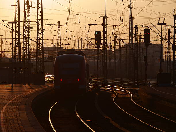 Train at station. View from above. Light reflecting on metal rooftop.