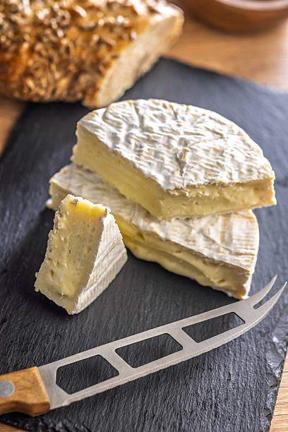 istock Camembert cheese on cutting board. French cheese with mold on the surface. 2237390988