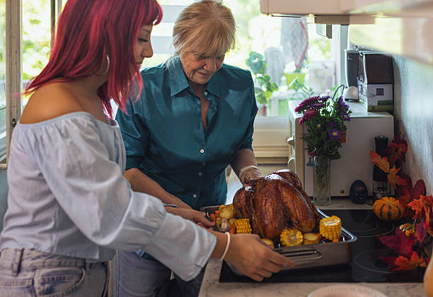istock Family preparing turkey for Thanksgiving Day 2237391534