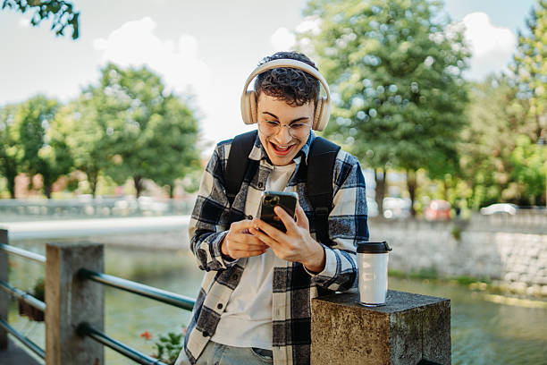 istock Young caucasian man student smiling and using smartphone 2237391642