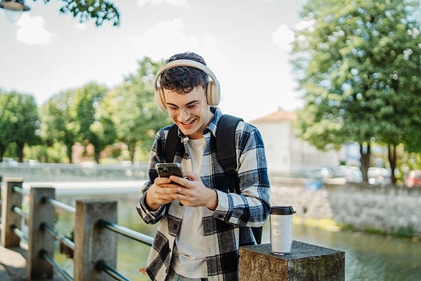 istock Young caucasian man student smiling and using smartphone 2237391717