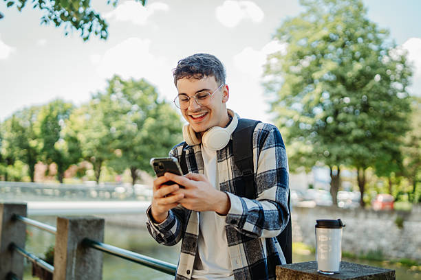 istock Young caucasian man student smiling and using smartphone 2237391893