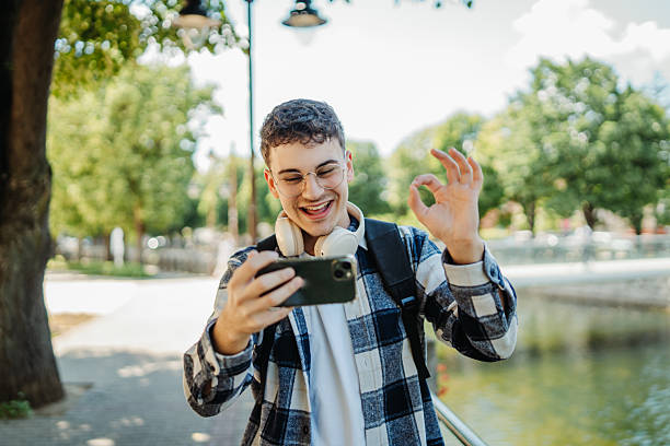 istock Young caucasian man student smiling and using smartphone 2237392338