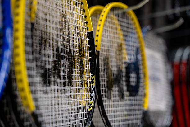 istock Close up view of yellow framed tennis rackets with white strings. 2237392599