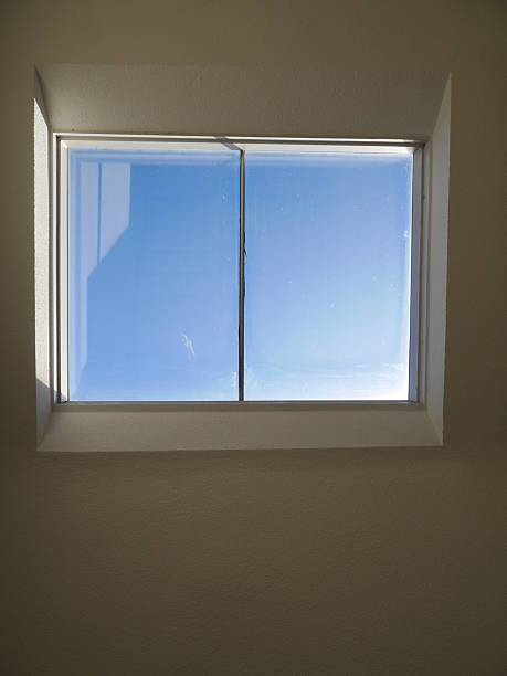 istock Window with a clear glass pane and a blue sky outside 2237395364