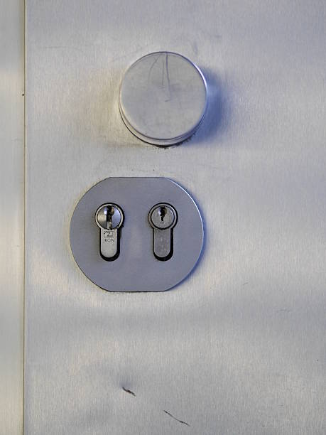 istock Silver door knob with two keys on it 2237395859