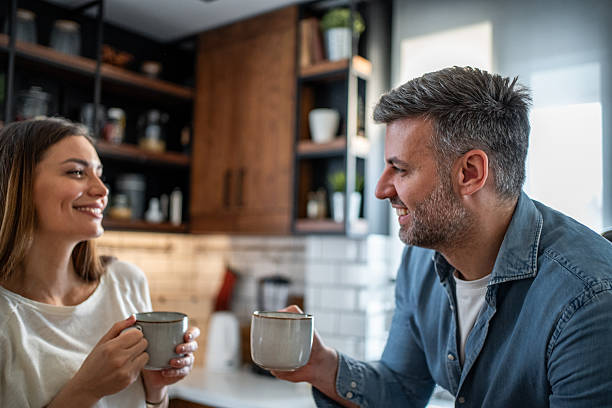 istock Happy couple enjoying morning coffee and conversation in kitchen 2237396416