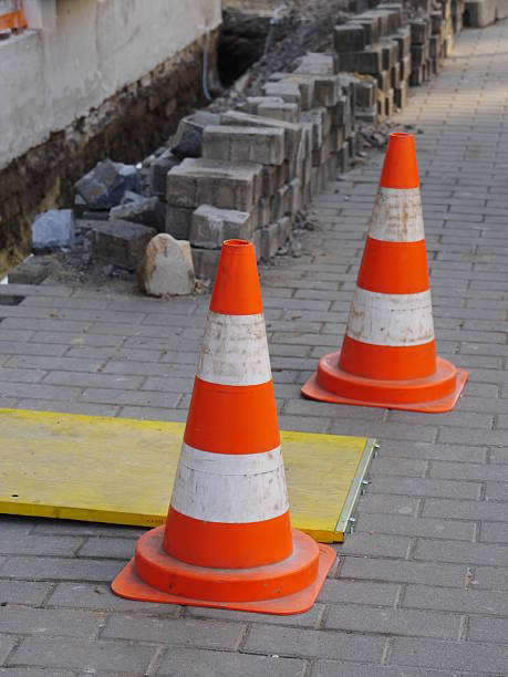 istock Two orange and white traffic cones are on a brick sidewalk 2237398201