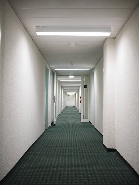 istock Long hallway with a green carpet and white walls 2237398806