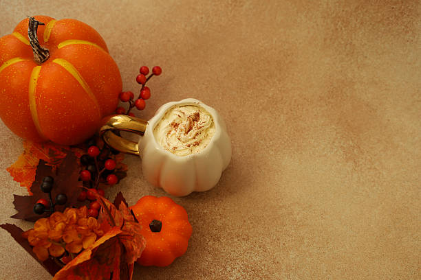 istock Colorful autumn decoration with pumpkins and dessert on a textured surface 2237399170